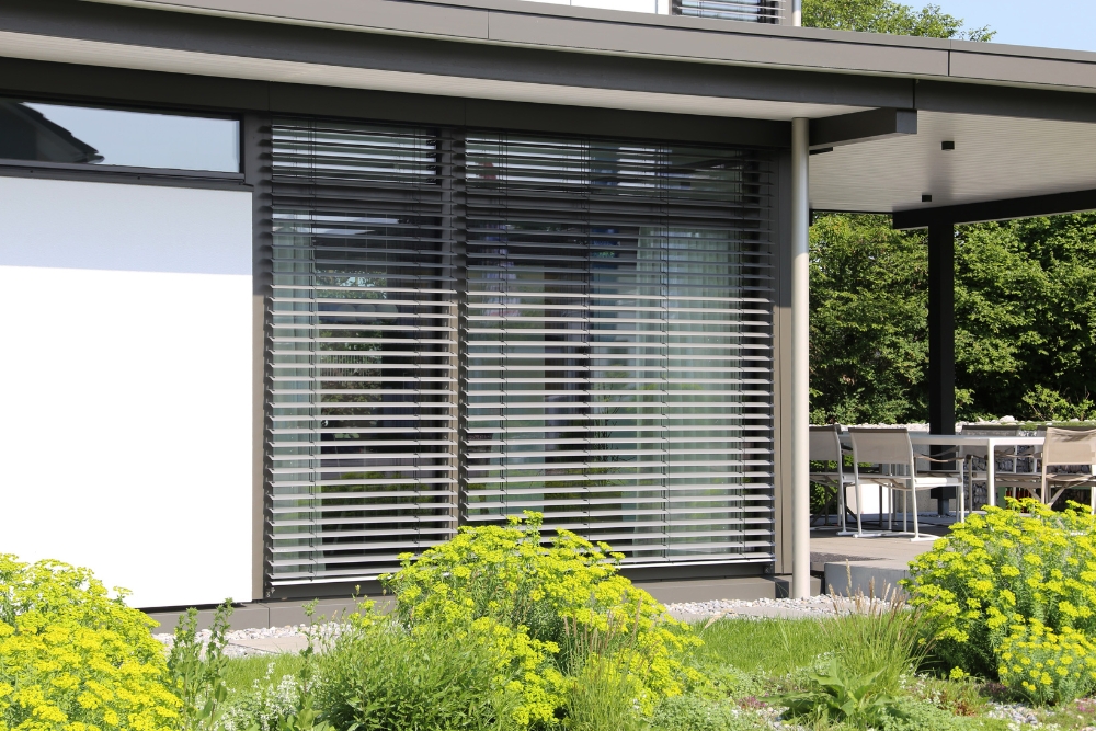 Contemporary home exterior with motorised blinds, enhancing energy efficiency and sun protection while adding a sleek and modern touch to the design.